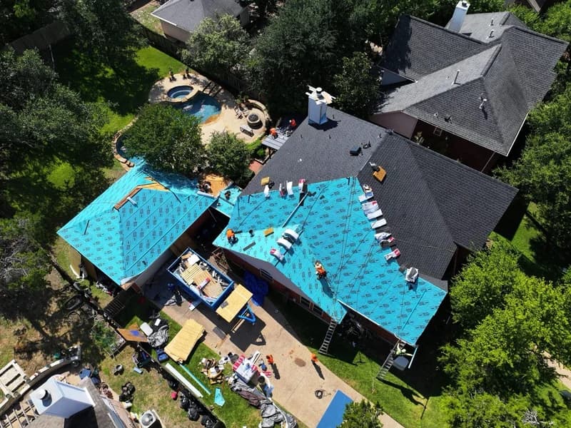 Texas home with metal roof under sunny blue sky showing heat-resistant roofing